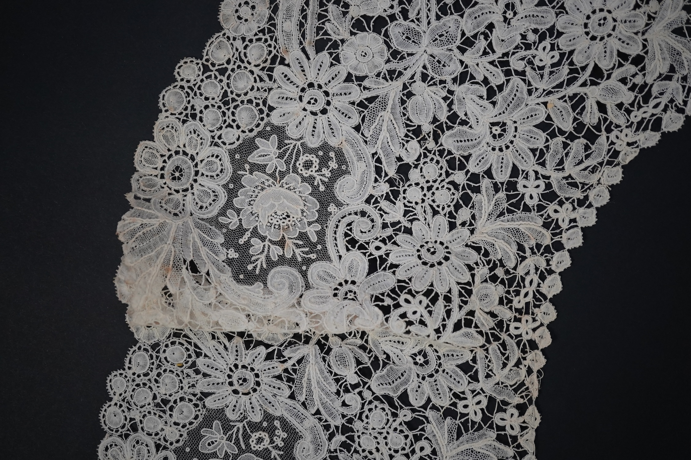 An 1860’s unused, large circular flounce shaped collar of mixed Brussels bobbin lace, with twelve needle lace Point de Gaz insertions, 18.5cm deep, approximately 248cm along bottom, edge. Condition - good